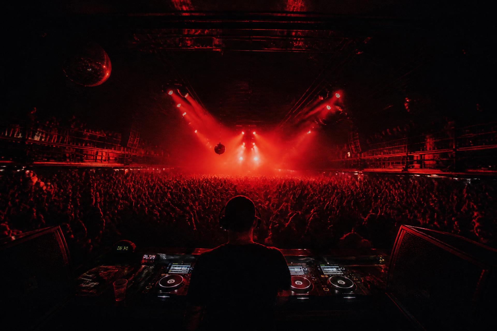 Packed crowd under red stage lighting at a B Rabbit Houston event